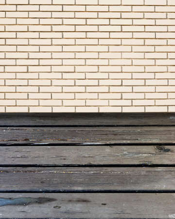 Wooden table with white brick wallの写真素材