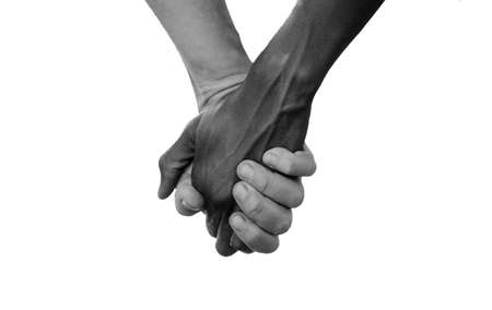 Black and White Hold Hands for Africa Union Peace Love. A beautiful shot with lots of possible background symbols. No to Racism! White woman holds hands with a little native African girl, in Mali.の写真素材