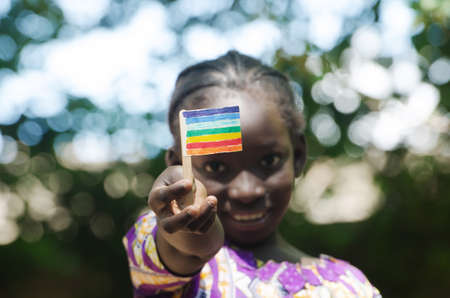 Young black African girl showing peace flag with her handsの写真素材