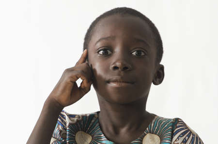 Little African child thinking has an idea, isolated on whiteの写真素材
