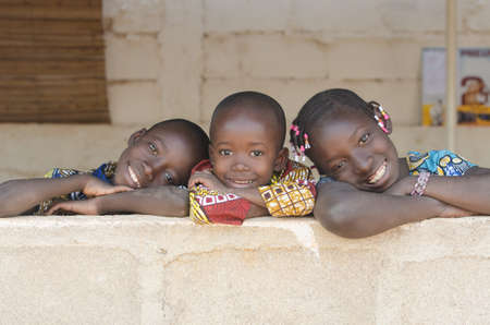 Three Adorable African Children Posing Outdoors Copy Spaceの写真素材