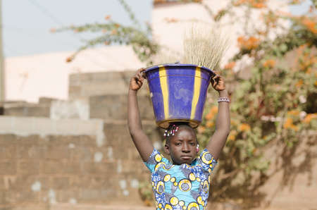 Child Labour Concept - Little African Girl Working for her Familyの写真素材