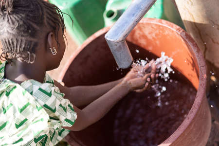 Cute African Ethnicity Offspring Transporting nutritious Water for an insufficiency concept