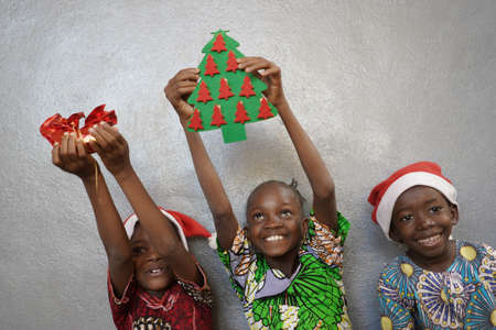 Three Beautiful African Boys and Girls Happy for Christmasの写真素材
