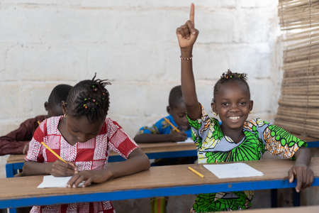 African School Children Raising Their Hands during Lessonの写真素材