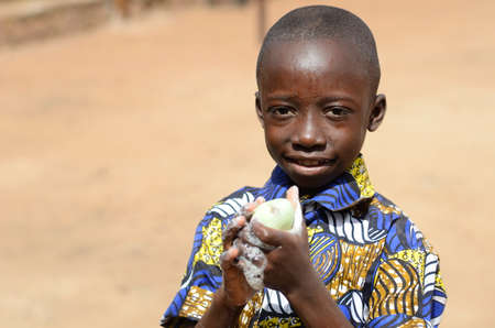 Handsome Little Black Boy Cleaning Hands Posing as a Health Concept Against Virus, Bacteria, Disease and Illnessの写真素材