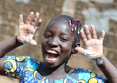 Gorgeous African Black Young Girl Happy About Washing her Hands with Sanitizer, Soap and Waterの写真素材
