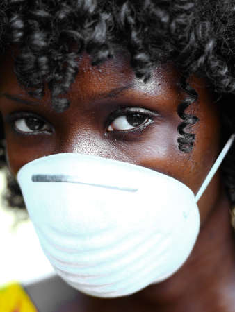 Portrait of African Woman Wearing Face Mask Against Infection of Bacterira, Virusの写真素材
