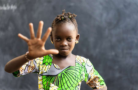 Portrait of African Black Girl Child Showing Palm of Hand as stop discrimination and racism