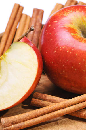 Still life with red apples and cinnamon sticks on whiteの写真素材