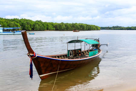 Long tailed boat floating on riverの写真素材