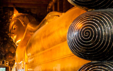 The Big golden Reclining Buddha within Wat Pho is the important in Bangkok, Thailand の写真素材