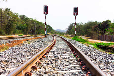 railway tracks with signals on background of scenery