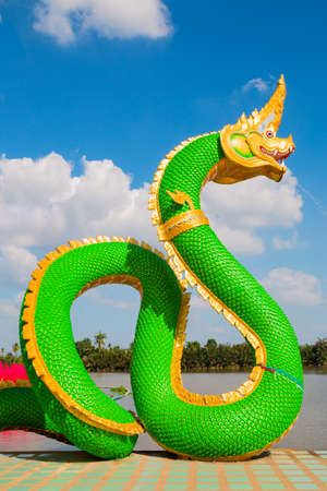 Thai dragon or Naga statue with blue sky background at Thailandの写真素材
