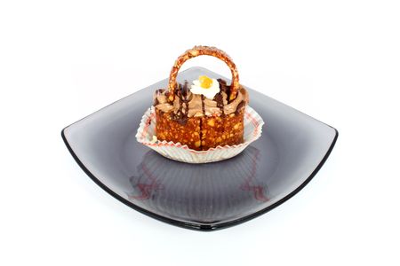 Little sweet candy basket on glass plate isolated on whiteの写真素材