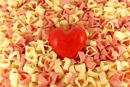 Colored pasta in form of heart with big red heartの写真素材