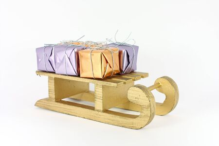 Little colorful gifts on sledge Christmas decoration isolated on whiteの写真素材