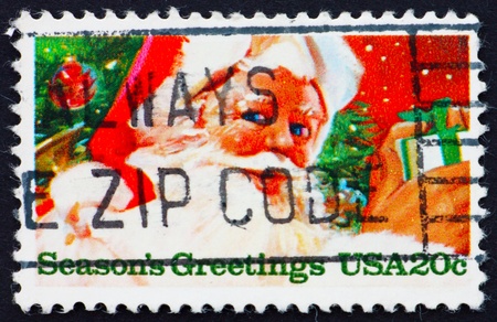 UNITED STATES OF AMERICA - CIRCA 1983: a stamp printed in the United States of America shows  Santa Claus with gifts, circa 1983の写真素材