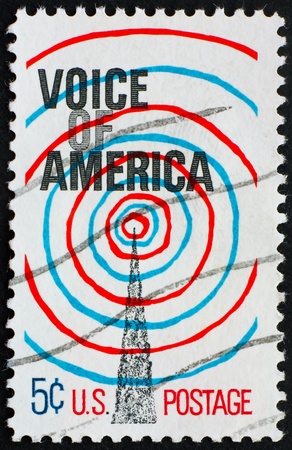 UNITED STATES OF AMERICA - CIRCA 1967: a stamp printed in the United States of America shows Radio Transmission Tower and Waves, 25th anniversary of the radio branch of the U.S. information Agency (USIA), circa 1967の写真素材