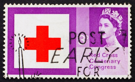 GREAT BRITAIN - CIRCA 1963: a stamp printed in the Great Britain shows Red Cross and Queen Elizabeth II, circa 1963のeditorial素材