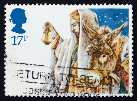 GREAT BRITAIN - CIRCA 1984: a stamp printed in the Great Britain shows Arrival of the Holy Family in Bethlehem, crayon sketch by Yvonne Gilbert for Christmas, circa 1984の写真素材