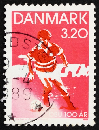 DENMARK - CIRCA 1989: a stamp printed in the Denmark shows Soccer player, Centenary of Danish Soccer Association, circa 1989の写真素材