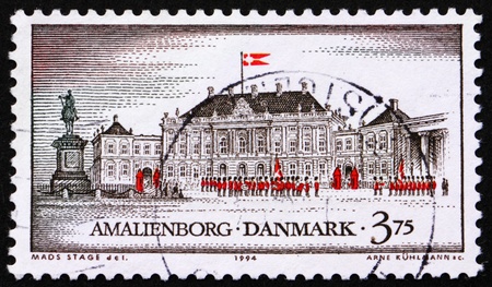 DENMARK - CIRCA 1994: a stamp printed in the Denmark shows Amalienborg Palace, Copenhagen, circa 1994の写真素材