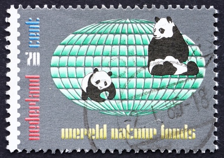 NETHERLANDS - CIRCA 1984: a stamp printed in the Netherlands shows Two Pandas and Globe, World Wildlife Fund, circa 1984の写真素材
