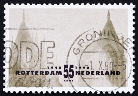 NETHERLANDS - CIRCA 1990: a stamp printed in the Netherlands shows Two Old Towers, Rotterdam Reconstruction after devastating bombardment in WWII, circa 1990の写真素材