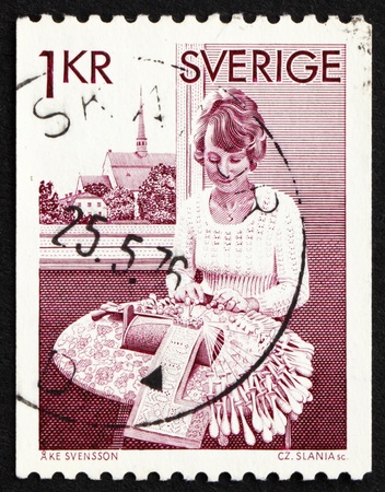 SWEDEN - CIRCA 1976: a stamp printed in the Sweden shows Bobbin Lace Maker from Vadstena, circa 1976の写真素材