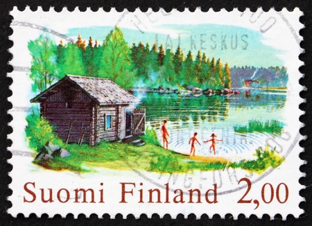 FINLAND - CIRCA 1977: a stamp printed in the Finland shows Chimneyless Log Sauna, circa 1977の写真素材