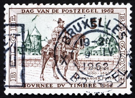 BELGIUM - CIRCA 1962: a stamp printed in the Belgium shows Postrider, 16th Century, Belgium, circa 1962の写真素材