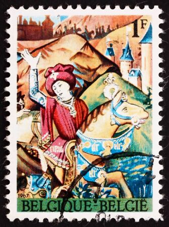 BELGIUM - CIRCA 1967: a stamp printed in the Belgium shows Caesar Crossing Rubicon, 15th Century Tapestry, circa 1967の写真素材