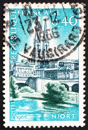 FRANCE - CIRCA 1966: a stamp printed in the France shows St. Andrews and Sevre River, Niort, France, circa 1966の写真素材