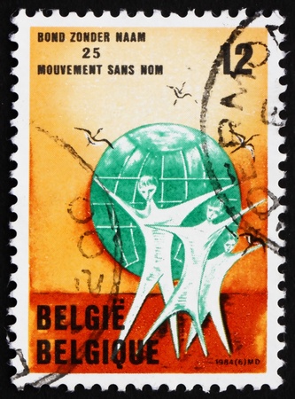 BELGIUM - CIRCA 1984: a stamp printed in the Belgium shows Family, Globe, Birds, Movement without a Name, Peace Organization, circa 1984の写真素材
