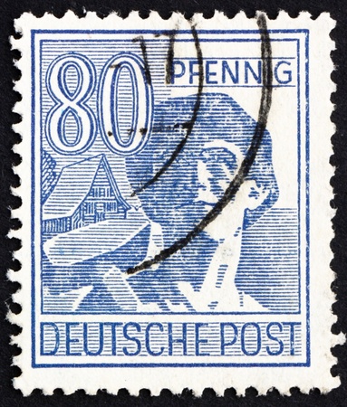 GERMANY - CIRCA 1948: a stamp printed in the Germany shows Laborer, circa 1948のeditorial素材