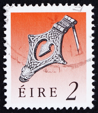IRELAND - CIRCA 1990: a stamp printed in the Ireland shows Silver Kite Brooch, Viking Age, Art Treasure of Ireland, circa 1990のeditorial素材
