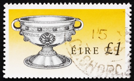 IRELAND - CIRCA 1990: a stamp printed in the Ireland shows Ardagh Chalice, Art Treasure of Ireland, circa 1990のeditorial素材