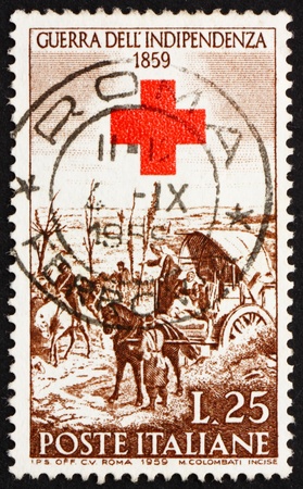 ITALY - CIRCA 1959: a stamp printed in the Italy shows After the Battle of Magenta, painting by Giovanni Fattori and Red Cross, Centenary of the War of Independence, circa 1959のeditorial素材