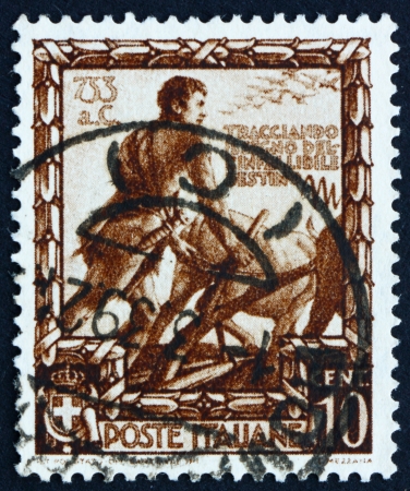 ITALY - CIRCA 1938: a stamp printed in the Italy shows Romulus Plowing a Furrow to Mark the Boundary of New City Rome, Proclamation of Italian Empire, circa 1938のeditorial素材