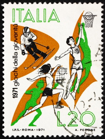 ITALY - CIRCA 1971: a stamp printed in the Italy shows Skiing, Basketball, Volleyball, Youth Games, circa 1971のeditorial素材