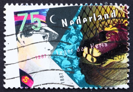 NETHERLANDS - CIRCA 1987: a stamp printed in the Netherlands shows Salvation Army and Homeless, Centenary of Salvation Army, circa 1987のeditorial素材