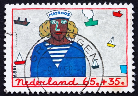 NETHERLANDS - CIRCA 1987: a stamp printed in the Netherlands shows Sailor, Childrens Drawing, Youth and Professions, circa 1987のeditorial素材