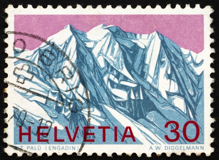 SWITZERLAND - CIRCA 1970: a stamp printed in the Switzerland shows View of Piz Palu, Grisons, Swiss Alps, circa 1970のeditorial素材