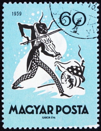 HUNGARY - CIRCA 1959: a stamp printed in the Hungary shows The Cricket and the Ant, Fairy Tale, circa 1959のeditorial素材