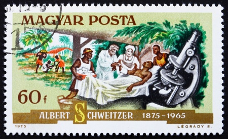 HUNGARY - CIRCA 1975: a stamp printed in the Hungary shows Dr. Albert Schweitzer, Patient and Microscope, Medical Missionary and Musician, circa 1975のeditorial素材