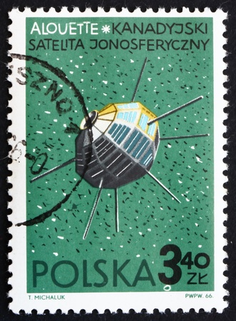 POLAND - CIRCA 1966: a stamp printed in the Poland shows Alouette, Canadian Satellite, circa 1966のeditorial素材
