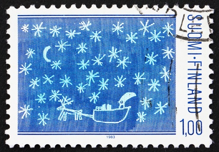 FINLAND - CIRCA 1983: a stamp printed in the Finland shows Santa, Reindeer, Sled and Gifts, Childrens Drawings, Christmas, circa 1983のeditorial素材