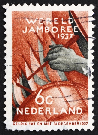 NETHERLANDS - CIRCA 1937: a stamp printed in the Netherlands shows Assembly of the Boy Scouts, Fifth Boy Scout World Jamboree, Vogelenzang, Netherlands, circa 1937のeditorial素材