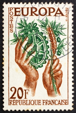 FRANCE - CIRCA 1957: a stamp printed in the France shows Hands with Symbols of Agriculture and Industry, United Europe for Peace and Prosperity, circa 1957のeditorial素材